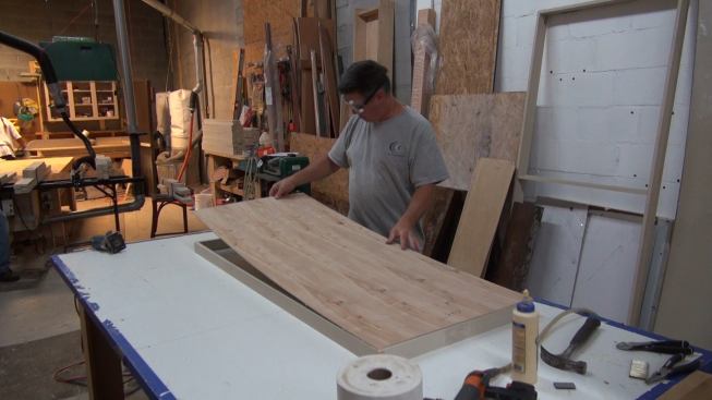Adding a plywood back to the sound-absorbing panel frame.