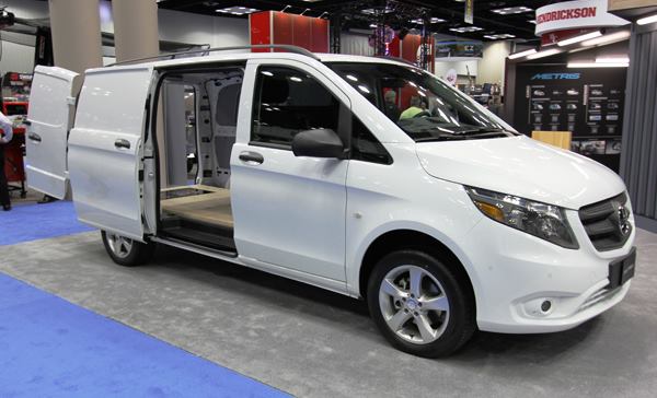 Install more seats and this would be your everyday suburban minivan. But the back of this Mercedes Metris contains only a 4x8 sheet of plywood—placed there to show how much storage space it has. The rear doors will close with 4x8 material inside. Company ads show the vehicle being used to carry a big stack of drywall—something you would not expect to see with such a small van.