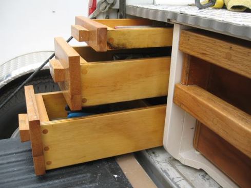 There are three drawers at either side of the bed. The lower two only go as far as the back of the wheel well.