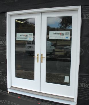 House wrap can be installed either before or after the door unit.