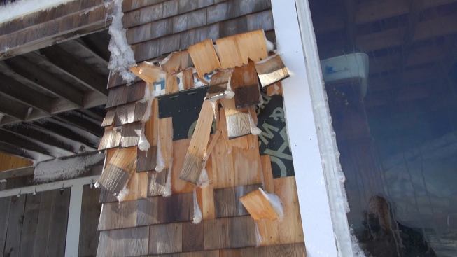 Shingles snapped by wave action during the storm on Joe Hackett’s house in Marshfield, Mass.