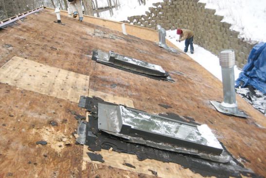 The north-facing roof sheathing over the vaulted living space suffered the most damage, while the sheathing over the unconditioned garage attic (shown here at the far end of the roof) showed virtually no damage at all.