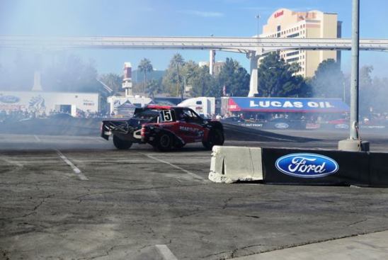 One of many racing trucks at the show burns rubber (REALLY burns rubber) on the main lot in front of the convention center. 
Click here for video.