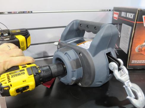 Warn makes winches, hoists and other kinds of vehicle equipment. Most of their winches mount on the front of a truck. But they also make smaller models; 
we reviewed their Pullzall, a 1,000 pound cordless model, a couple of months back. The Drill Winch (shown here) is set to come out in January 2015. It has a 500-pound capacity, 30’ of wire cable, and can be powered by almost any cordless drill.