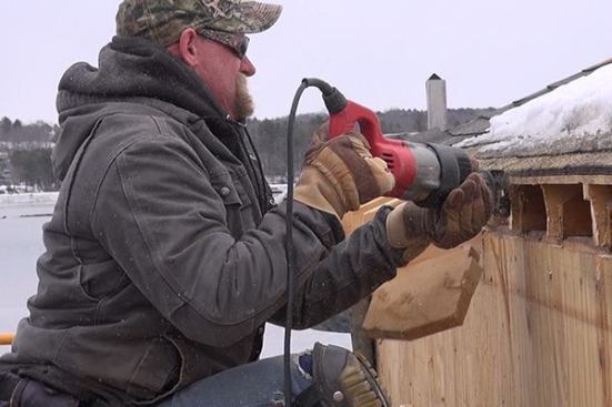 EcoCor job foreman Dan Armstrong cuts the ends off the home’s existing rafters with a Milwaukee Sawzall. The crew will then run a new air-tight vapor control layer membrane up the side wall and onto the roof, creating an air-tight connection from wall to roof at this juncture.