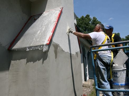 For the most part, just a finish coat of synthetic stucco was applied. Though, in few locations, like the chimney, the stucco subs applied a base coat over the existing stucco. They applied the finish coat working top to bottom.