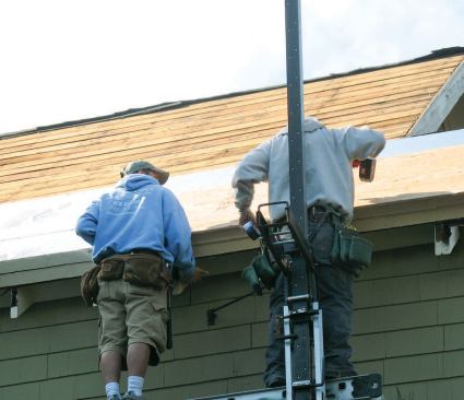 After stripping the existing roofing, the crew installed two staggered layers of 3-inch-thick rigid foam.