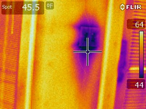 Similarly, the  purple and pink spots on this thermal image of a light switch in an exterior wall show the cold areas due to poor insulation and air-sealing.