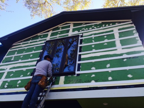 The author had more confidence in "fingerpainting" with the fluid-applied barrier than in using tape to seal the seams in the sheathing.