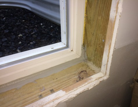 We injected a high-quality polyurethane sealant into the gap below and on the sides of the window unit, creating a retrofit sealant pan before installing extension jambs.
