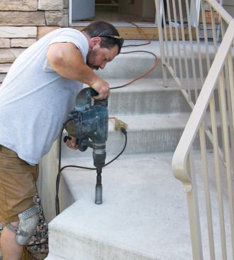 The shop's installer used a hammer drill equipped with a core bit to make holes in the steps.