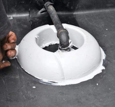It's glued to the roof with a pourable sealant.