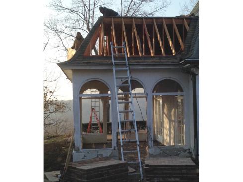 We broke up the job into two phases because of the late-November start date. For the first phase, our plan was to complete the demo work and foundations, then button up the place before the snow started. We began by removing the existing porch roof. It was a trapezoidal shape and had a flat top covered with single-ply EPDM. We stripped off the shingles, cut up the sheathing, and carefully removed the rafters by hand so as not to damage the main house.