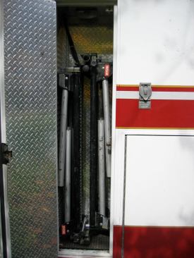 This broom closet-size compartment just behind the cab contains a folding miter saw stand. Note the 15-amp 110-volt AC receptacle to the right of the opening. It is powered by a 1500-watt inverter and is one of three receptacles on or in the module.
