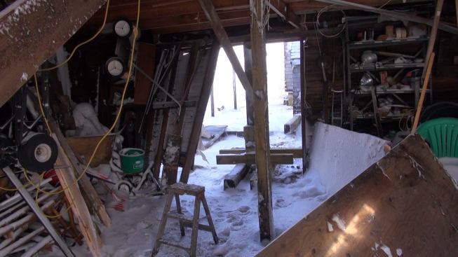 A view of the damaged back wall of contractor Joe Hackett’s garage next to his oceanfront house in Marshfield. Despite Hackett’s temporary emergency repair, town officials had tagged the structure as unsafe.