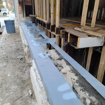 The cross braces will hold the steel legs together and serve as brackets to secure the ends of new floor joists.