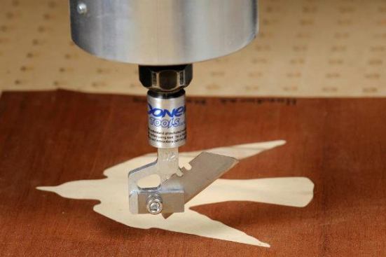 Here's what the drag knife looks like when it's chucked into a CNC machine. Instead of spinning (like it would when it contained a router bit) the machine cuts by "dragging" the knife across the surface of the material to be cut. It can turn on a dime and make extremely precise cuts.