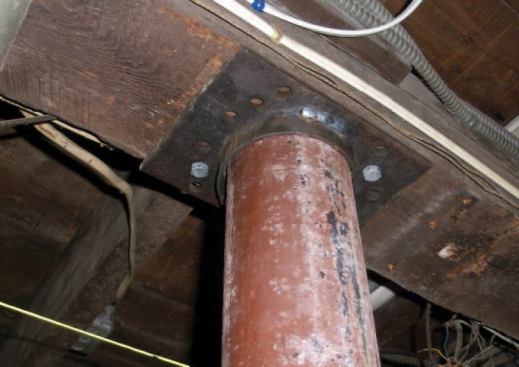 When I'm satisfied the column is plumb, I remove the nearby jacks, putting the weight of the house on top. I run two 3/8-inch-by-2-inch galvanized lag screws into the beam.