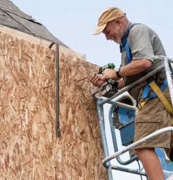 The wall panels were first glued and nailed to the glulam band and splines, then fastened to each other and to existing framing with structural screws.