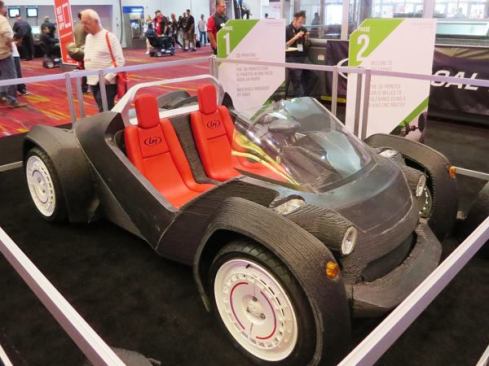 You’re looking at the Strati EV, the world’s first 3D printed electric car. Developed by 
Local Motors, the plans for the car are open source so anyone with a big enough 3D printer (big as in giant) can make one. It took 4 days to print the parts made from plastic: the chassis, body, and seats. 
Click here for a manufacturer’s video of the production process.