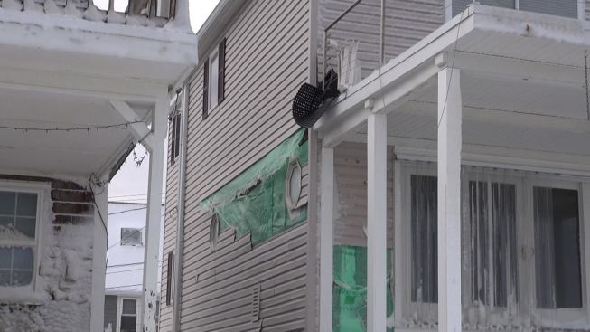 The weather ripped some vinyl siding off the side wall of this house near the Marshfield seawall breach.
