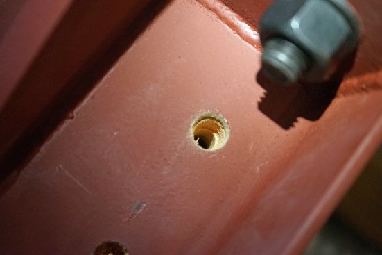 Each bracket required 20 lag screws, and each hole for the lag screws was predrilled using two different drill bits—one sized for the threaded shank and one for the shoulder of the lag.
