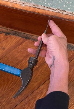 When you need to preserve a board, you can't mar the face with a catspaw. Instead of pulling nails, use an 1/8-inch pin punch to drive finish nails through the back of the board.    When the punch has been driven deep, it's sometimes hard to pull back out, but you can pry it out with the claw of a hammer.