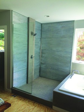 In the finished shower, the metal panels create a brighter space and the desired industrial look.