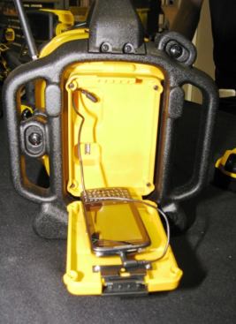 The right side of the radio has a compartment that will hold a smart phone or MP3 player. The device can be connected to the auxiliary port and played through the speakers and connected to the USB port (see left side of compartment about half way down) for charging when the radio is plugged in. There are two 10-amp electrical receptacles on the other side of the radio.