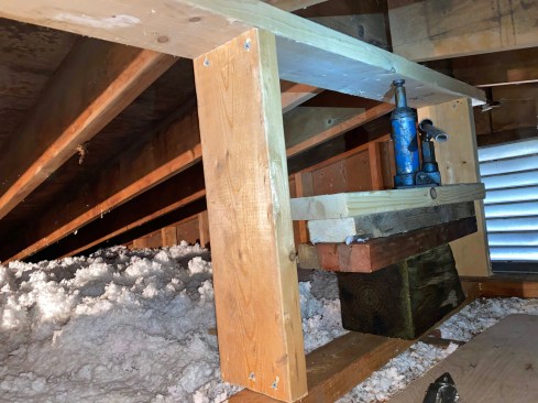 Before infilling with short studs, the author jacked the top plate up as much as possible to push up any rafters that had dropped down.