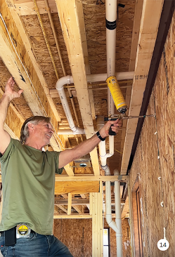Once the home is dried-in, attention shifts to air-sealing and insulation. Site supervisor Matt Kulp of Daks Builders seals the gaps between the SIPs.