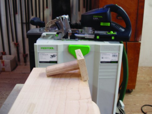 For cutting the inside mortise on the stiles, the author makes this simple jig with a 7/16-inch block (to match the depth of the molded edge) and an extra domino tenon.