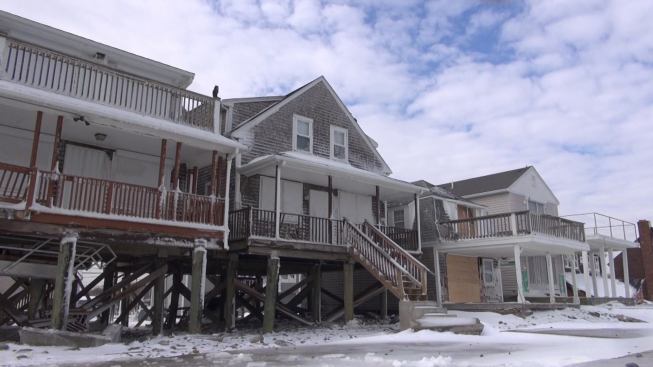 Elevated homes a few lots away from the large seawall breach survived better, but still experienced some damage.