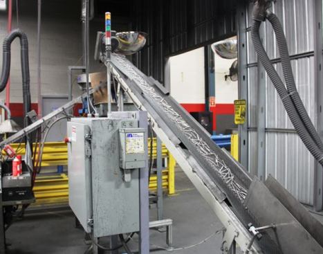 The now finished ring nails are conveyed to a second rotary feeder that positions them edge-to-edge prior to being wire-collated.