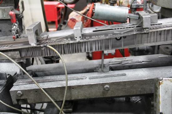 After the framing nails are made they are fed into a rotary orienting feeder (ROF) that places them side-by-side for collating. ROFs are extremely common; you’ll see them in any plant where individual pieces (of metal, plastic, food—you name it) must be placed in a particular position for processing. 
Click here for video.