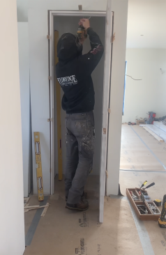 The last step is to shim and screw the head jamb to keep it from sagging.
