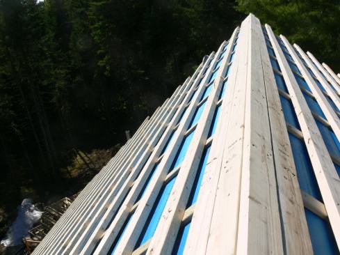This view of the roof ridge shows the completed strapping system extended all the way to the roof peak.