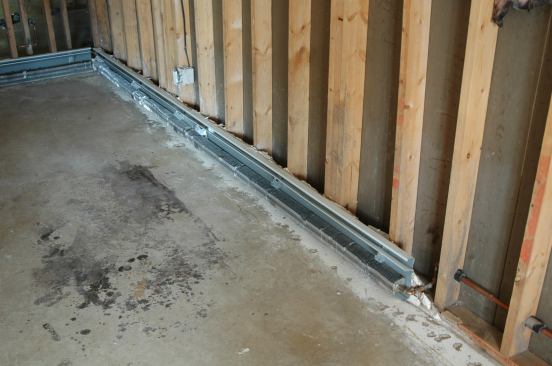 The metal components of the baseboard radiators were easy enough to clean (and a big job to replace) so they remain in place. The drywall behind the radiators has yet to be removed to finish the job.