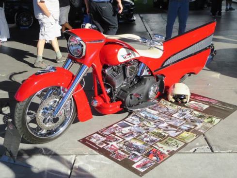 I wish I could say this was the result of a collision between a 1957 Chevy Bel Air and a 2008 Harley Davidson, but in fact it’s the result of 3,000 hours of labor by Lupo Racing, a car restoration company in France. Look closely and you’ll see there is more Bel Air to this bike than the fin, there’s the two-tone color scheme, the hood ornament on the fender and a piece from the bumper (the chrome cone) just forward of the motor. Can’t see it here, but the exhaust ports through a piece of the bumper—the same as it does on the car.