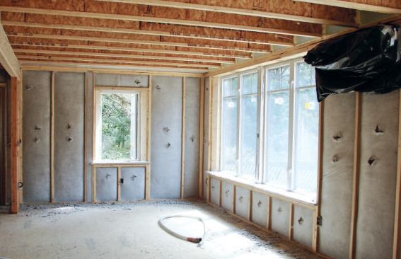 Because of the 9 1/2-inch cavity created by the double 2x4 walls, the blown cellulose achieves an R-value of 31. The sides of the deep window wells are beveled 45 degrees to ensure that they let in plenty of light.