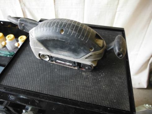 The Porter cable 2.5 x 14" belt sander (model 371K) is extremely useful for scribing. I can connect my dust collector to it, and use it one-handed. It has the perfect amount of torque for edge scribing. I keep 60 grit paper on mine.