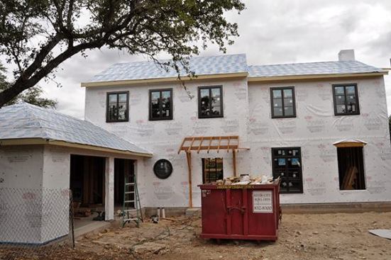 Tape is completed and the whole house gets DuPont Tyvek Commercial Drainwrap as the WRB over the OSB.