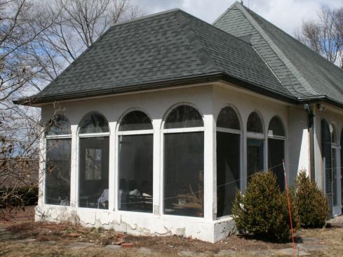The scope of work included tearing down the existing 13-by-18-foot screened porch on the south end of the house and replacing it with a larger, 15-by-22-foot sunroom; providing a new bedroom and sitting area above the new sunroom; remodeling part of the existing second floor adjacent to the new living space; adding new dormers to both the existing and new roofs; and reroofing and re-stuccoing the entire home. In this slideshow, we’ll focus on the work relevant to the four-season room.