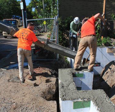 Placing concrete into the form system.