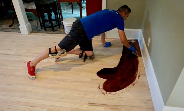 Somodean begins by pouring out a puddle of Ciranova oil, spreading it quickly in a broad sweep and working it skillfully to the edges.