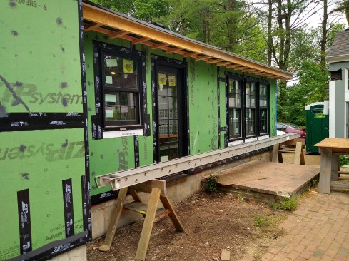 For optimal water and air detailing, we apply Zip Liquid Flash over all nail holes, loose tape, or scratches in the green Zip WRB. In this area, we built the soffit over the Zip R-3. The sheathing connects to the air-sealing layer that travels 1 inch below the roof sheathing. This allows an overroof for airflow.