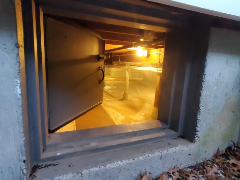 Access hatches from the exterior into a crawlspace and from the interior into a knee-wall attic area are often leaky. For each one, we took care to build insulated access hatches with Zip System sheathing and foam-rubber gaskets.