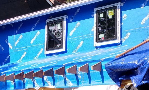 Where exterior insulation without sheathing was added, the crew created window bucks to project the windows to the proper plane. Impeccably wrapping the buck is critical in keeping the barrier congruous.  
