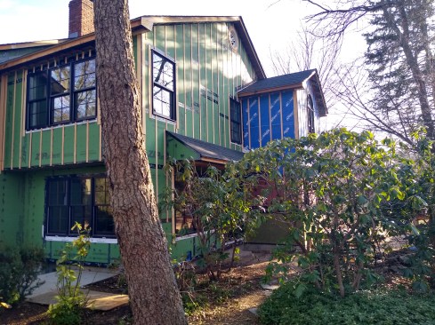 Strips of 1/4-inch marine plywood act as the rainscreen. The windows are positioned to drain behind the siding and out.  