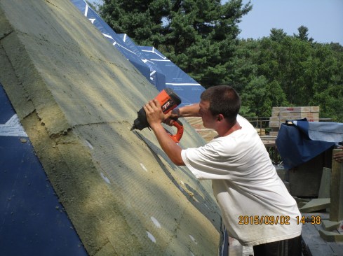 The carpenter uses a Ramset gas-fueled fastening gun to drive spiral-shank nails through the pointed end of a plastic tube fastener.